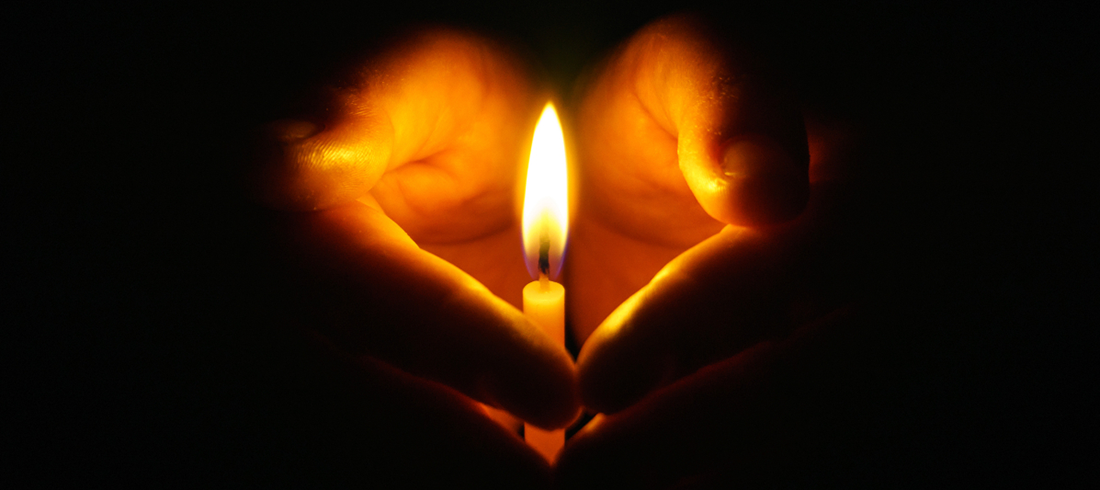 Candle Covered by Hands